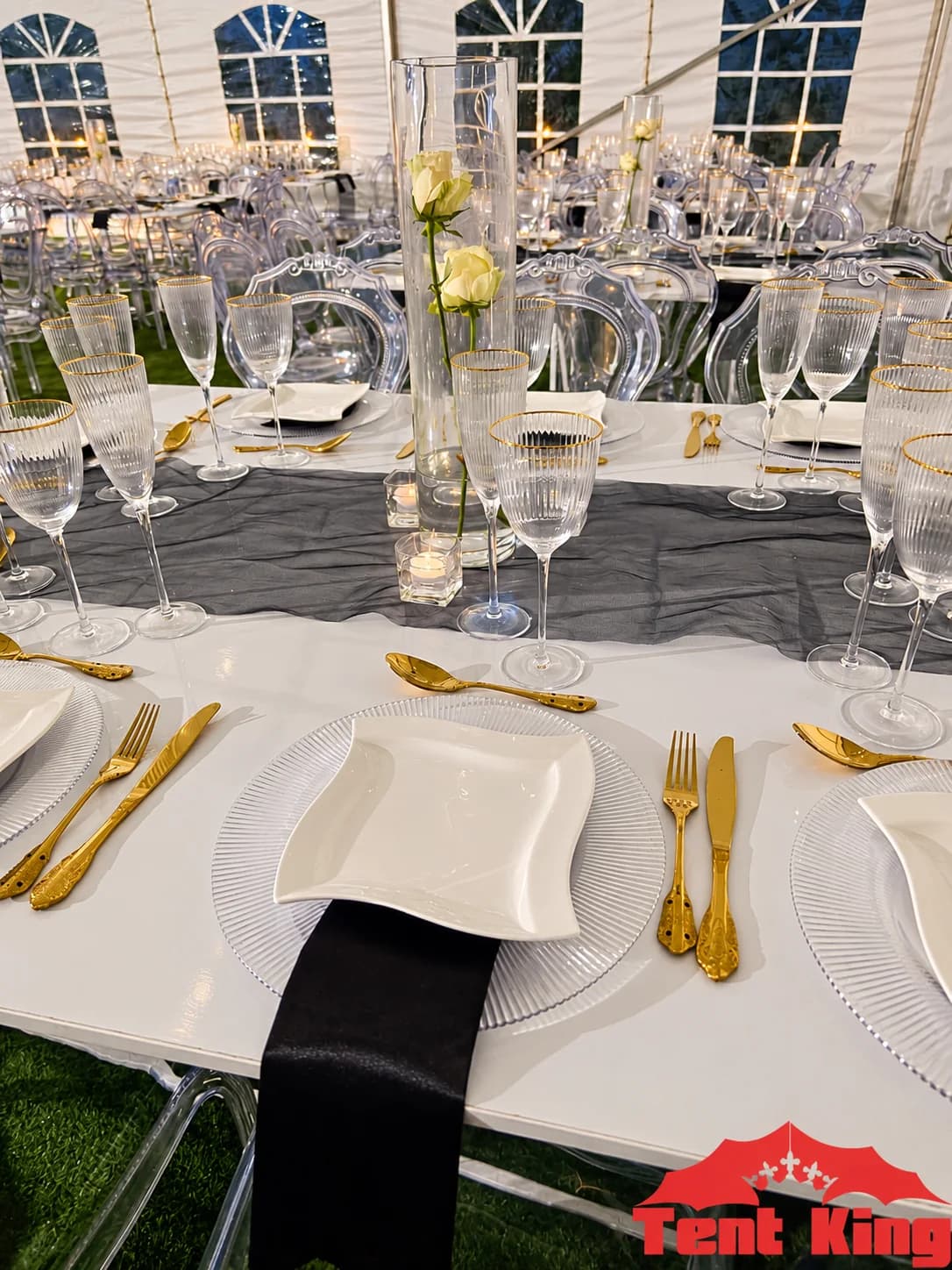 Elegant Tent King catering and tableware setup with gold cutlery and glassware